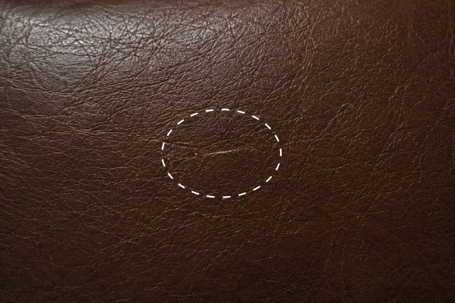 Fine surface scratching across brown leather, still sitting in the topcoat