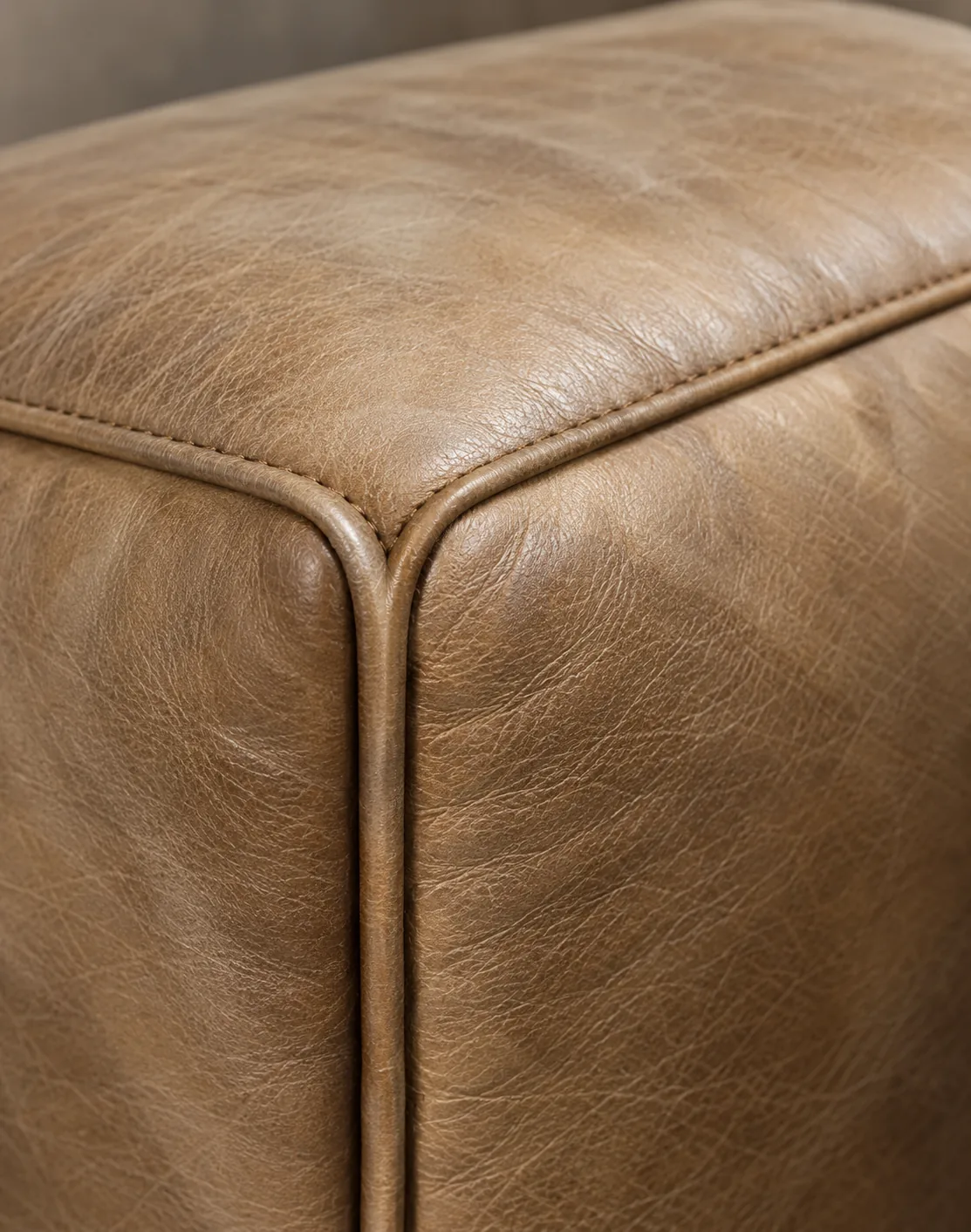 Taupe bench corner with the finish thinned across the raised edge