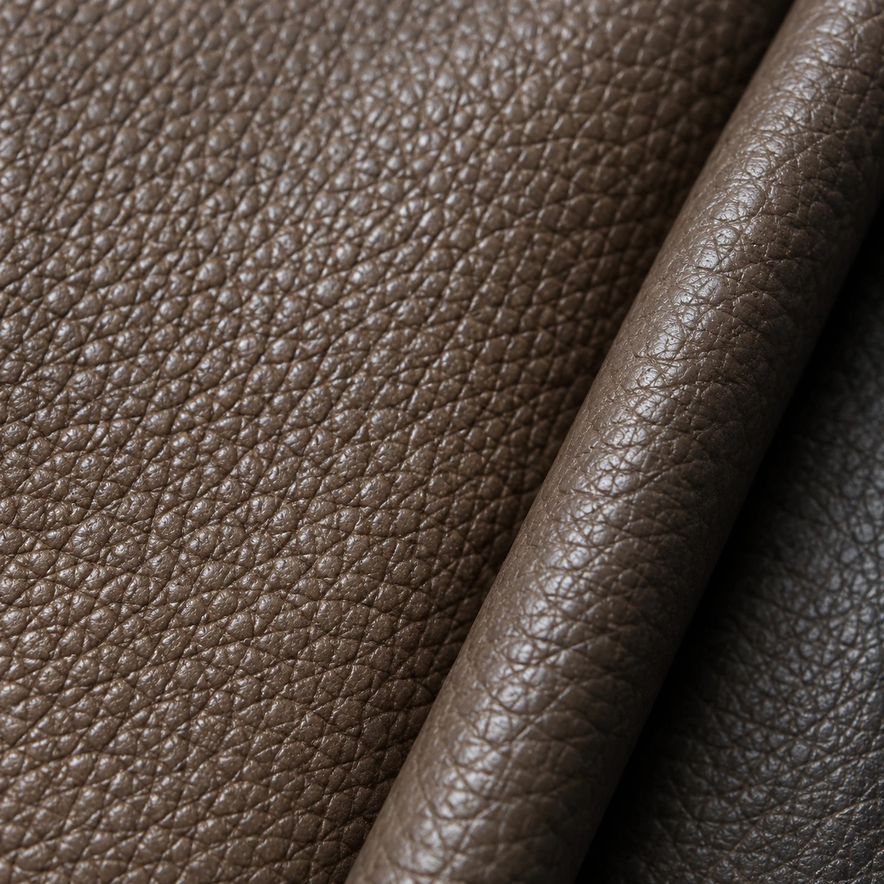 A taupe leather swatch with a pronounced, evenly pressed pebble grain