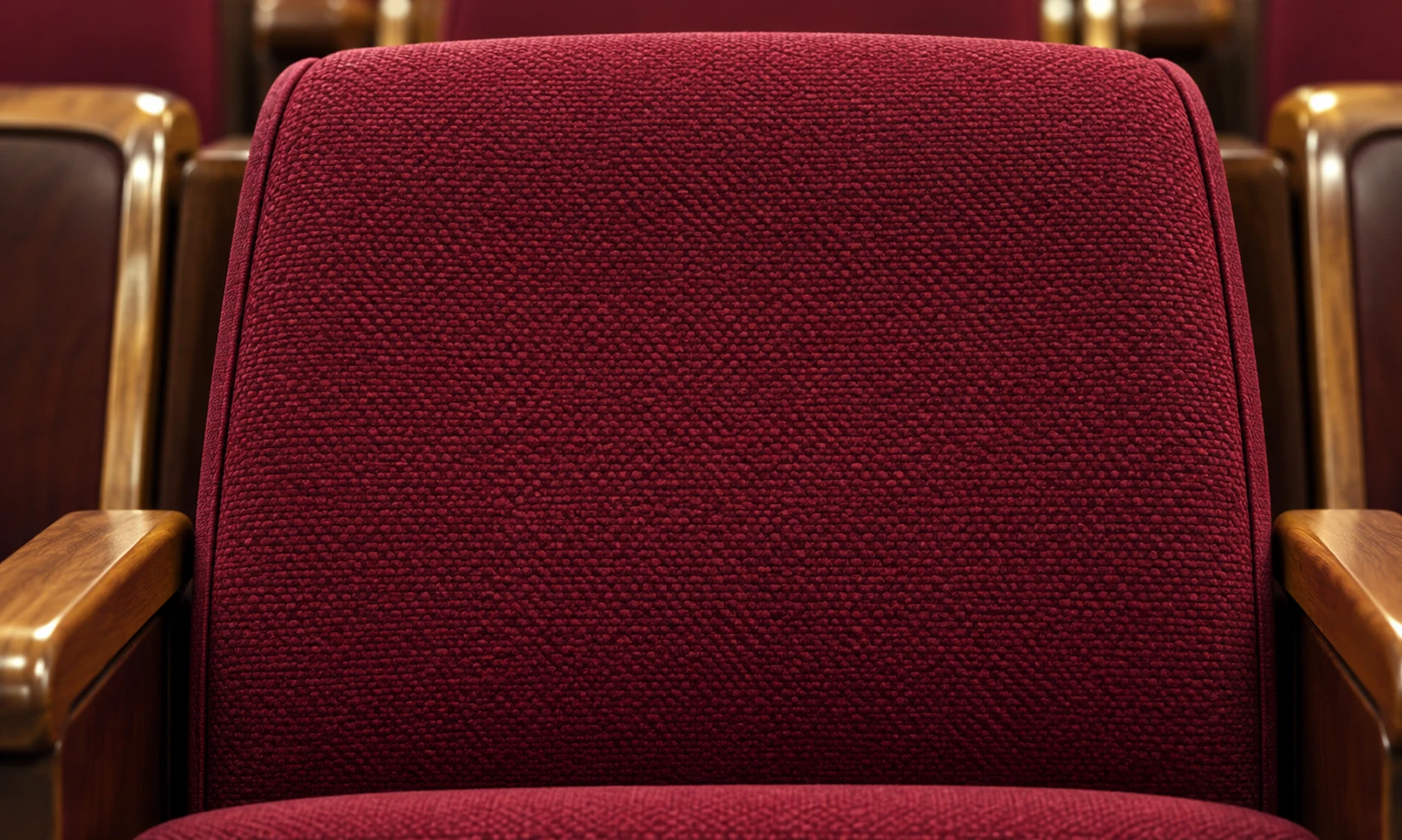Woven burgundy backrest panel between two wood arms
