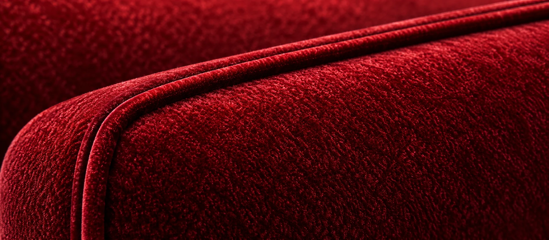 Welt and piping on a red velvet theater seat