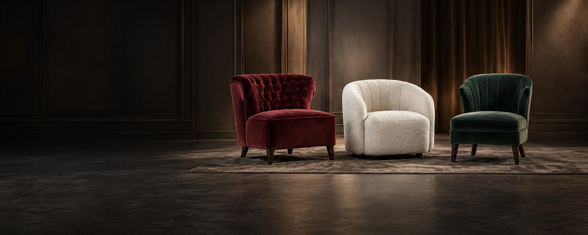 Three reupholstered chairs in burgundy velvet, cream boucle and green velvet in a dark panelled room