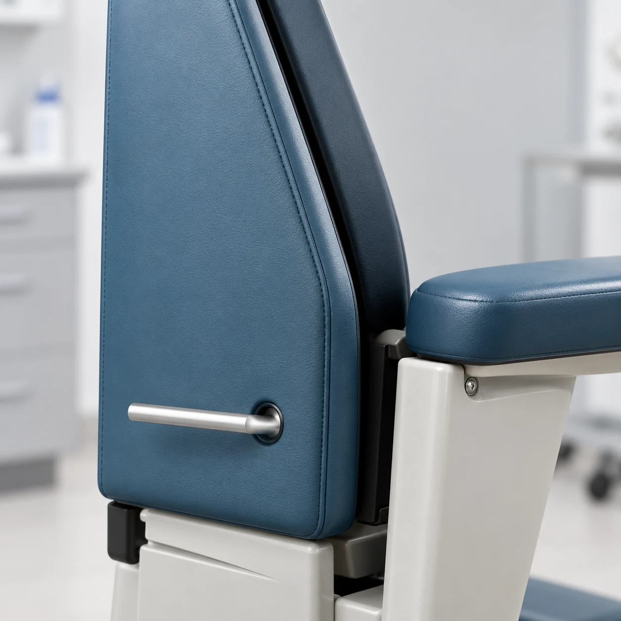 Grab handle passing through a grommeted opening in a treatment chair back panel