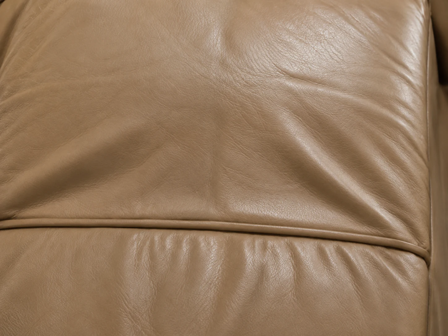 Uneven seat cushion surface with a high side and a worn hollow