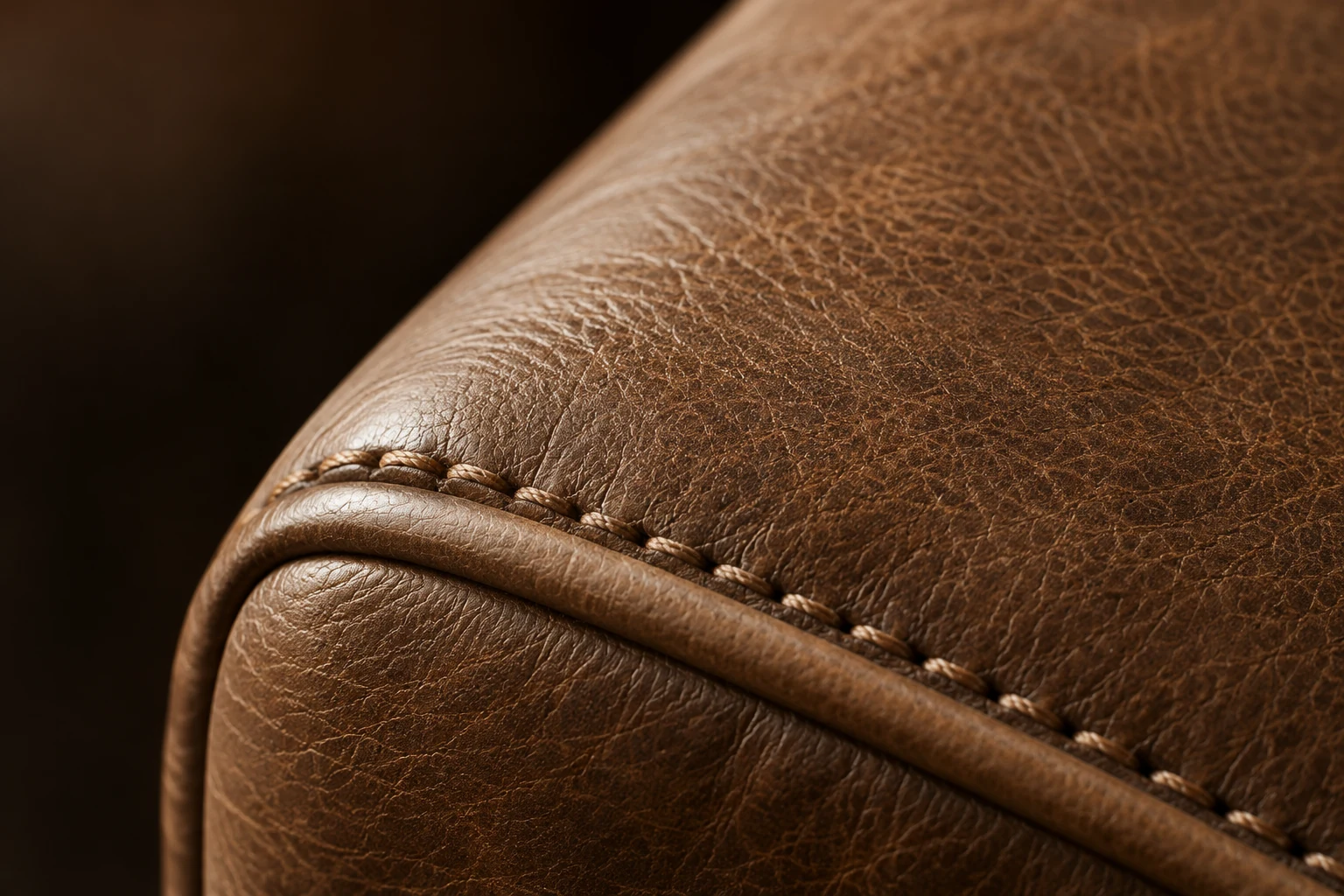 Hand saddle stitching worked along a brown leather welt