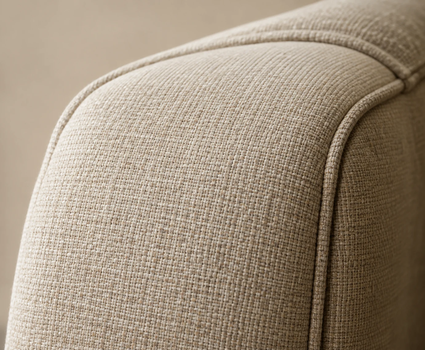 Finished linen cover with a welted seam over a rolled arm