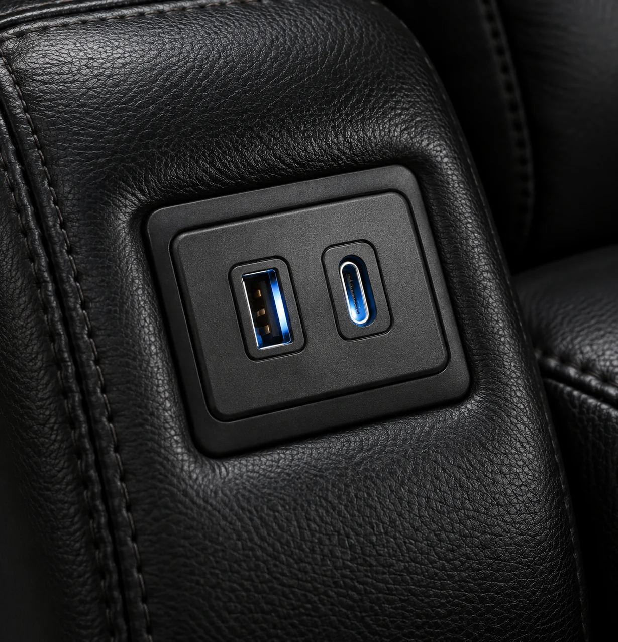 USB-A and USB-C charging ports set into the arm of a home theater seat
