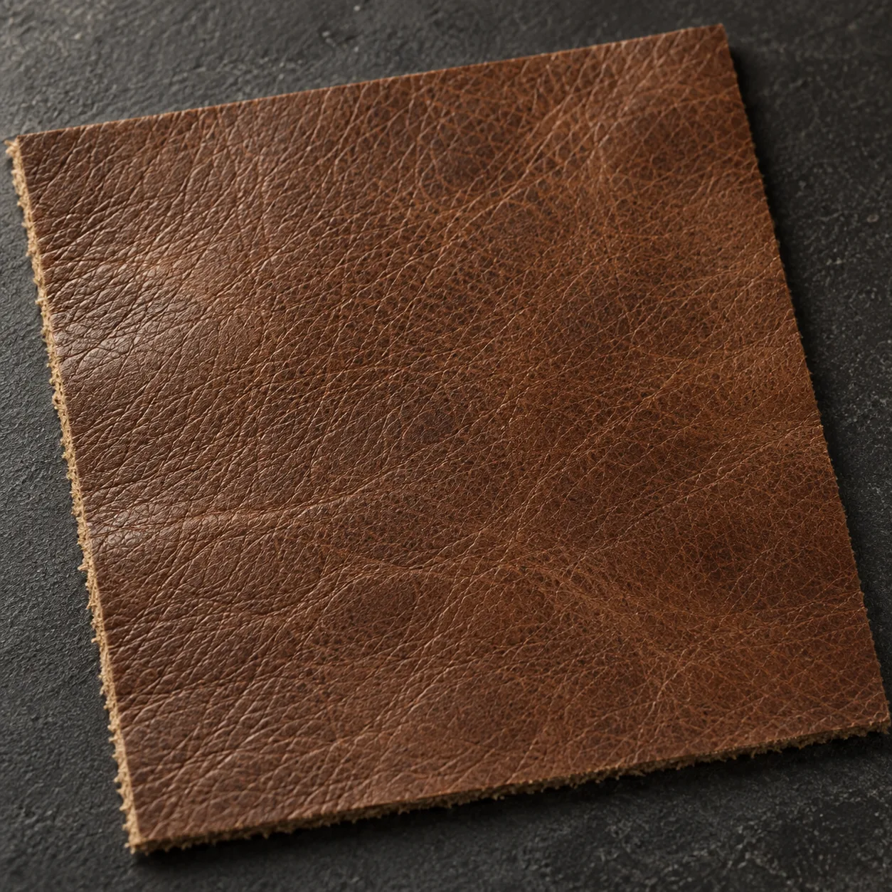 A swatch of dark cognac commercial vinyl for an executive chair