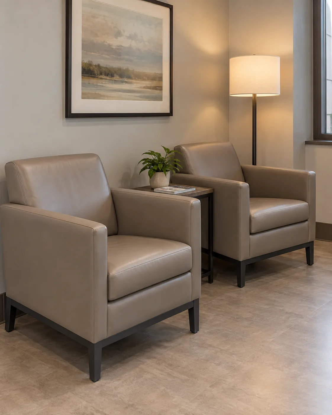 A pair of taupe lounge chairs in a waiting room