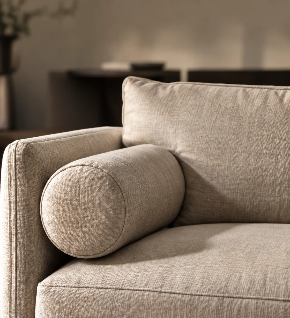 Cream leather sofa with a bolster cushion