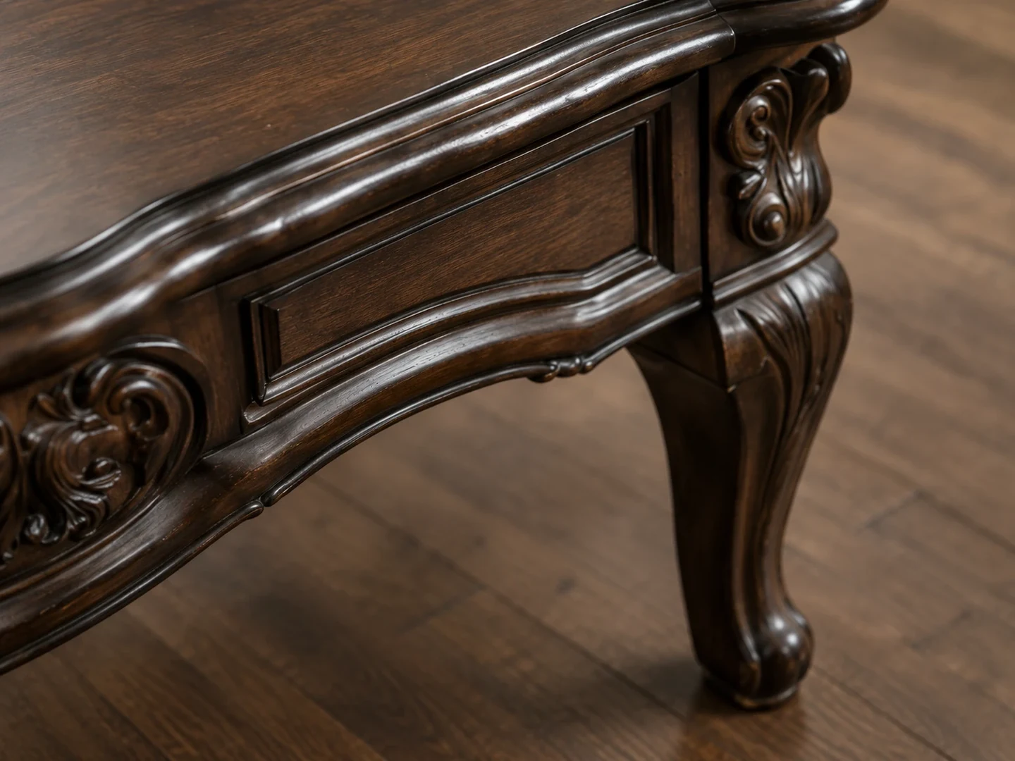 Carved dark wood table edge and cabriole leg