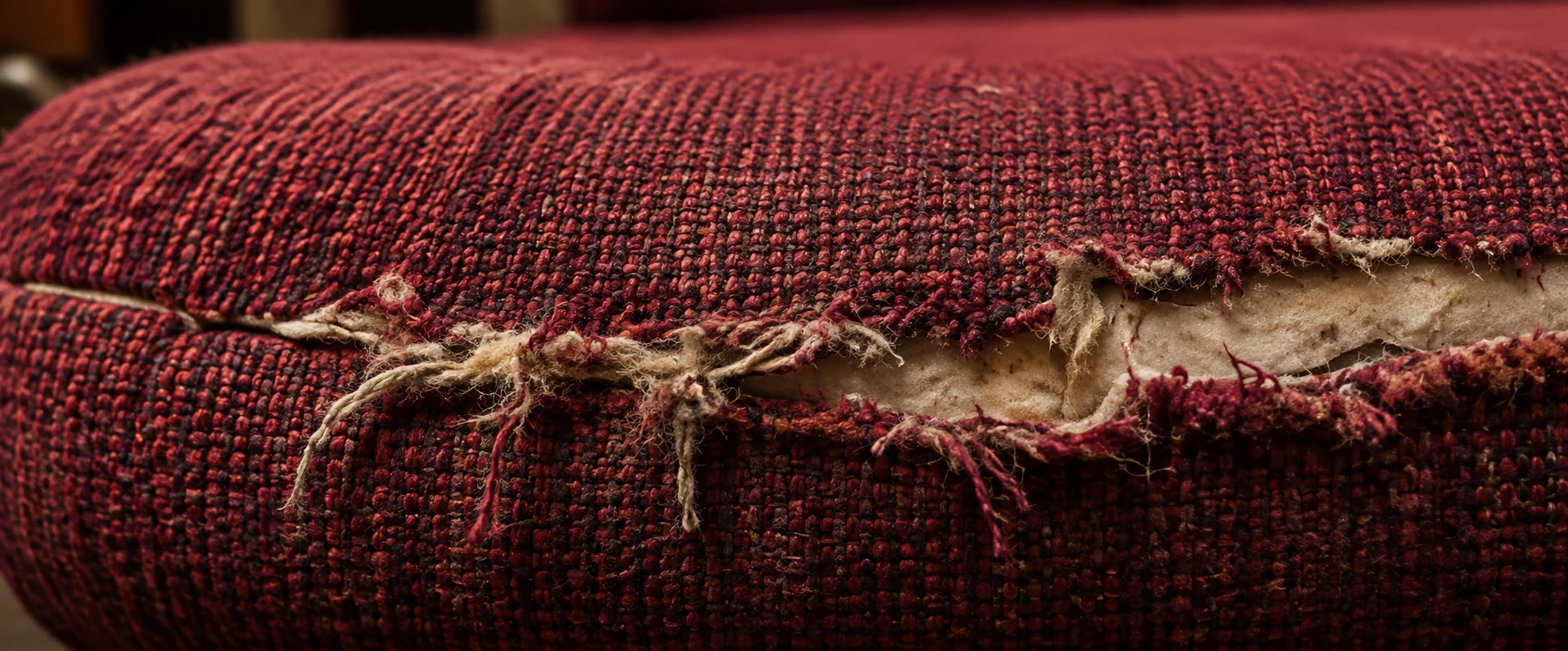 Frayed front edge on an auditorium seat cover