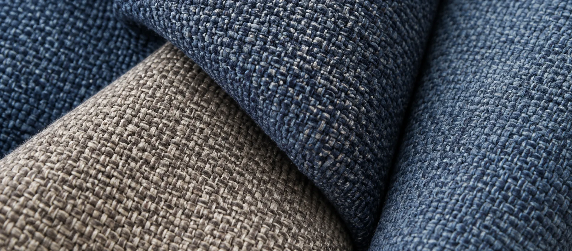 Woven upholstery fabric swatch rolls in navy and taupe