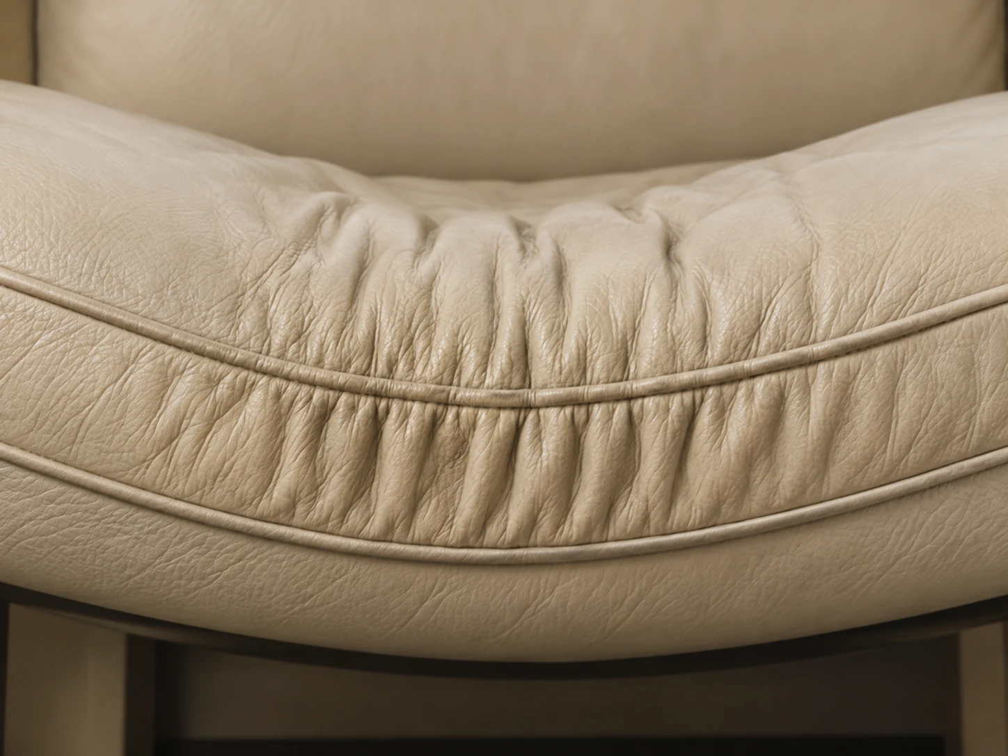 Wrinkled cream leather cushion cover that has stretched away from the core