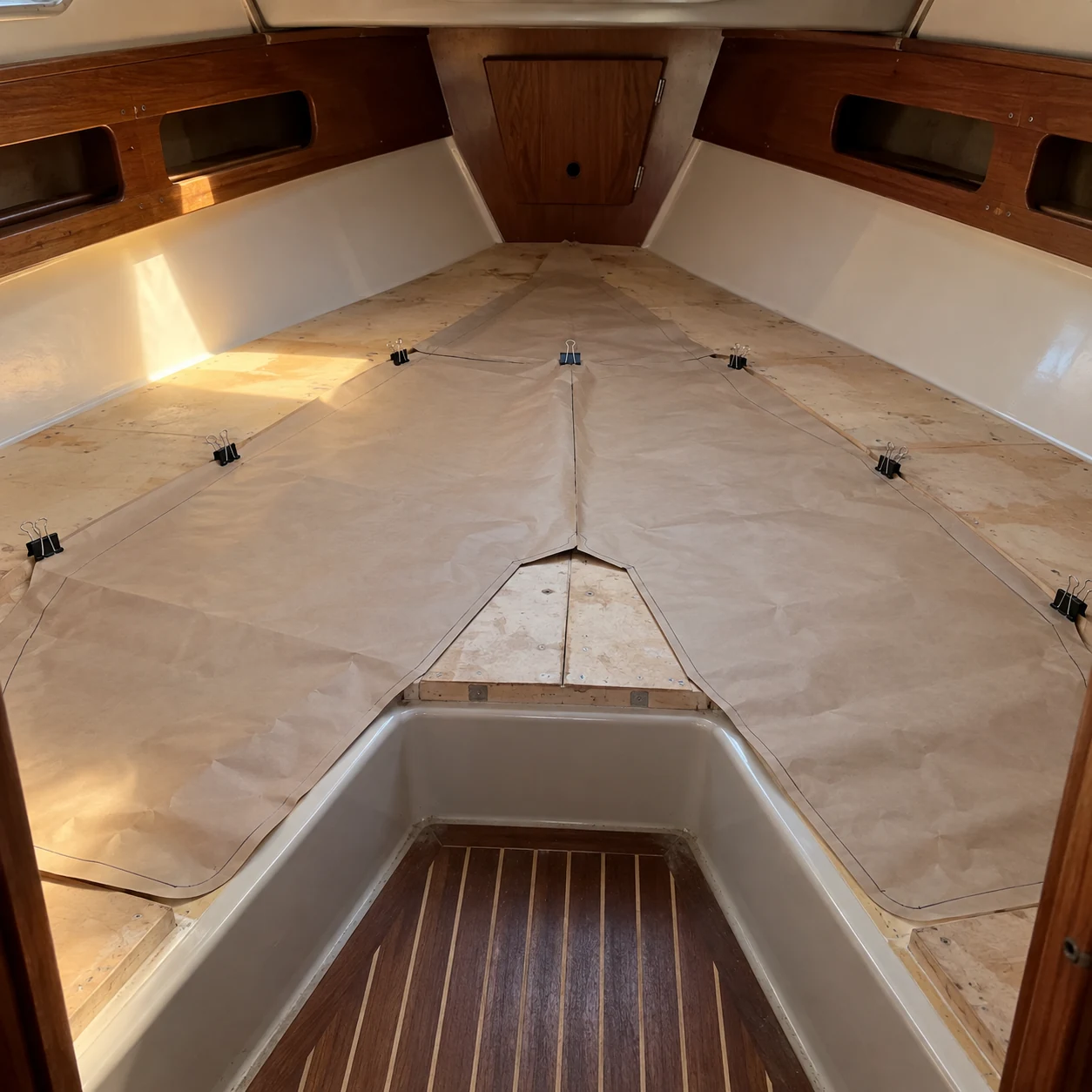 A paper cushion template laid out in a yacht V-berth